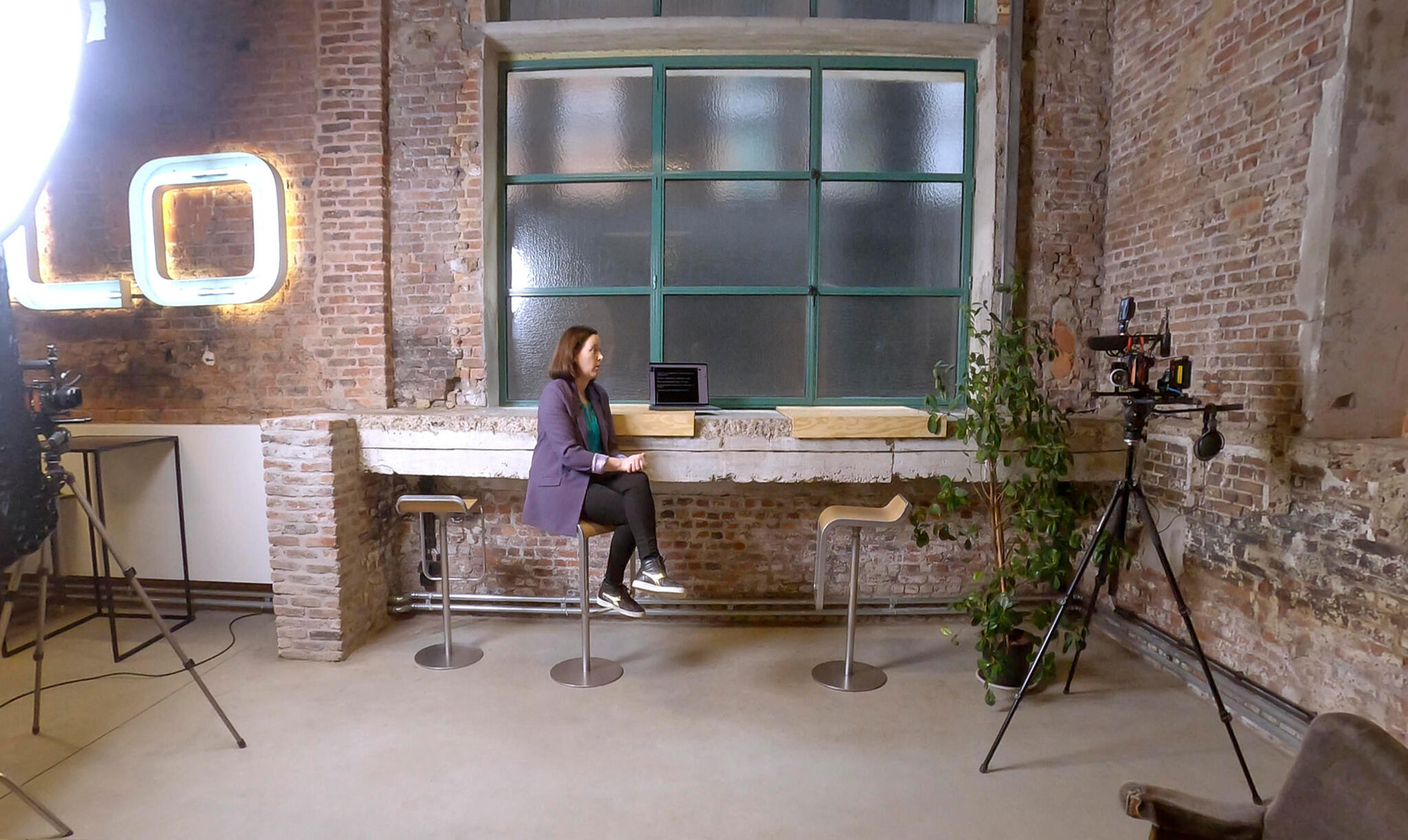 Sarah Martens sitting in the Freelance Flix recording studio.